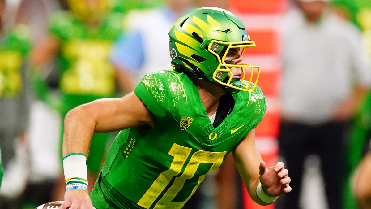 Sep 3, 2022; Atlanta, Georgia, USA; Oregon Ducks quarterback Bo Nix (10) scrambles out against the Georgia Bulldogs during the third quarter of the Chick-fil-A kickoff game at Mercedes-Benz Stadium.
